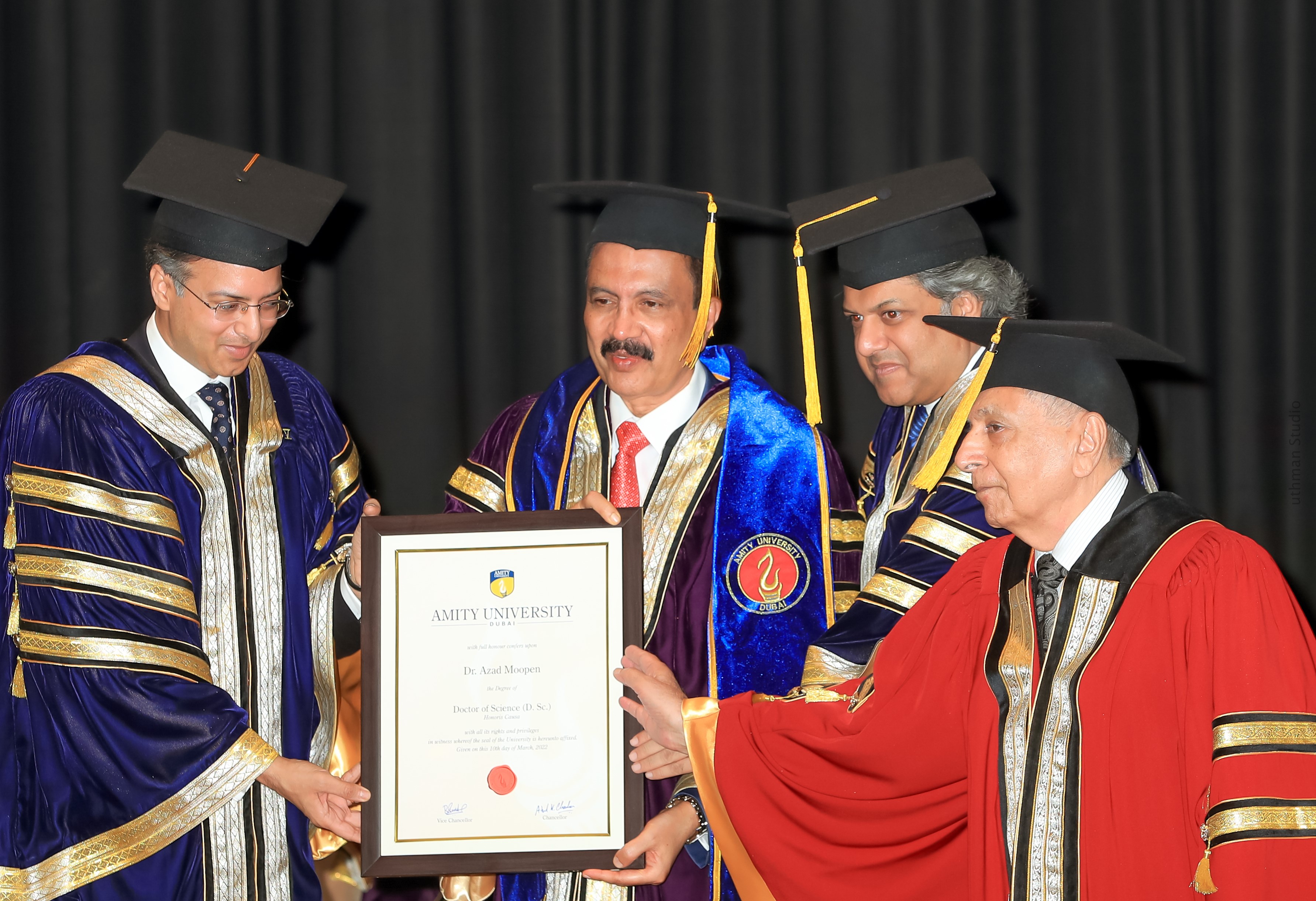 Picture Dr Azad Moopen Founder Chairman and MD Aster DM Healthcare receiving the Doctorate for Philanthropy certificate for his commitment to serving m