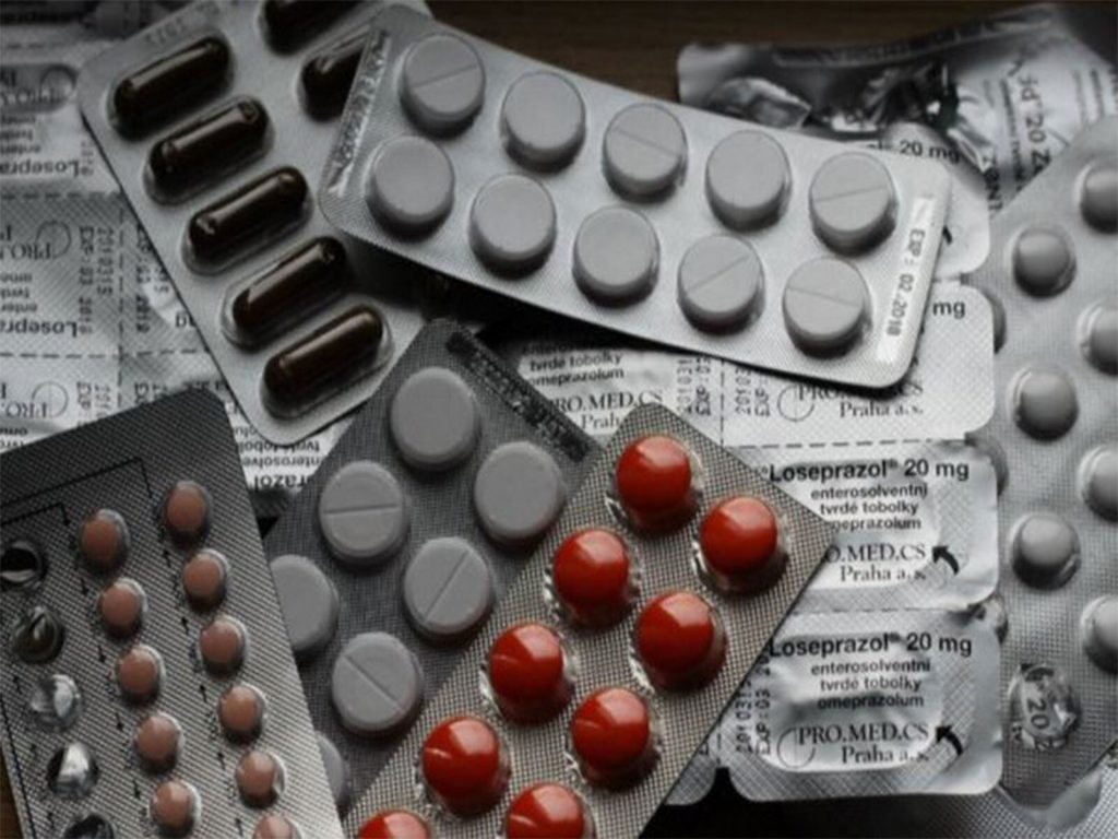 Hospital medicines and pharmaceutical drug pricing with tablets and capsules in blister packs.